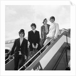 The Beatles on the steps of a plane by Associated Newspapers