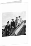 The Beatles on the steps of a plane by Associated Newspapers