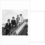 The Beatles on the steps of a plane by Associated Newspapers