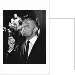 Boxer Henry Cooper smoking a pipe by Associated Newspapers