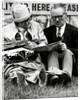 Racegoers relaxing by Associated Newspapers