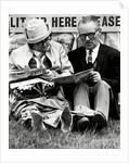 Racegoers relaxing by Associated Newspapers