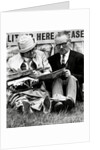 Racegoers relaxing by Associated Newspapers