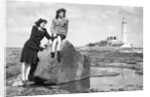 On the beach by the lighthouse at Whitley Bay by Associated Newspapers