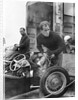Stirling Moss maintains his car at the British Grand Prix by Associated Newspapers