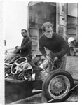 Stirling Moss maintains his car at the British Grand Prix by Associated Newspapers