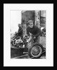 Stirling Moss maintains his car at the British Grand Prix by Associated Newspapers