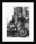 Stirling Moss maintains his car at the British Grand Prix by Associated Newspapers