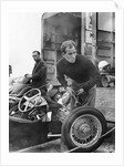 Stirling Moss maintains his car at the British Grand Prix by Associated Newspapers