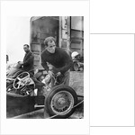 Stirling Moss maintains his car at the British Grand Prix by Associated Newspapers