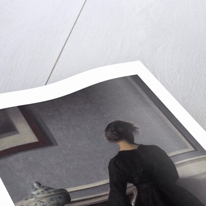 Interior with Young Woman from Behind by Vilhelm Hammershøi