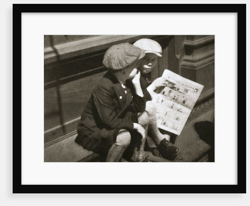 Two boys reading the comic section of the Sunday paper, New York, USA, 1931 by Unknown