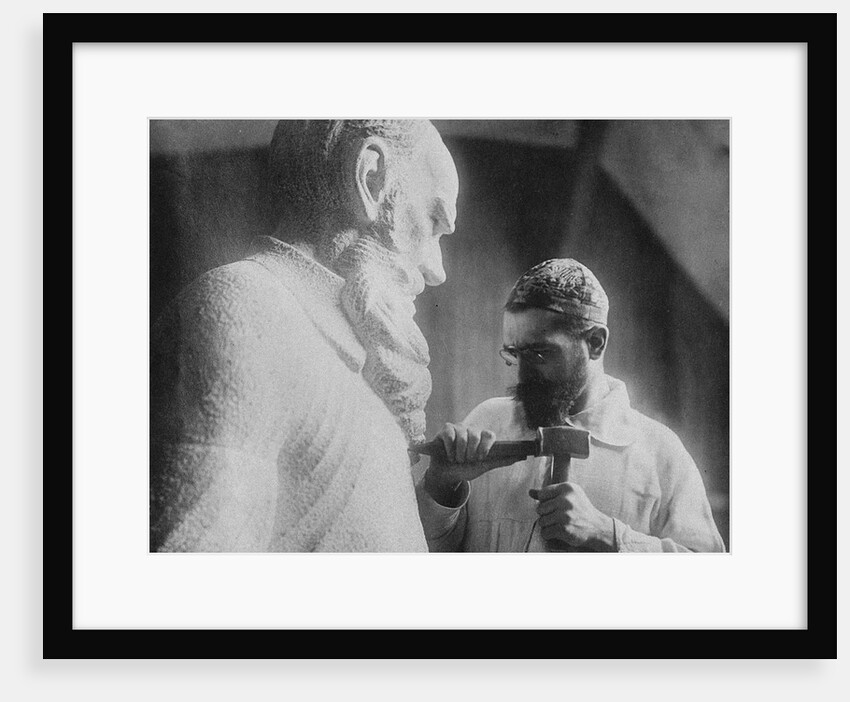 Russian sculptor Sergey Merkurov working on his statue of Leo Tolstoy by Anonymous