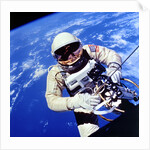 US Astronaut Edward H. White II carrying out external tasks by Unknown