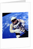US Astronaut Edward H. White II carrying out external tasks by Unknown