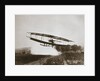 American aviator Glenn Curtiss making the first heavier-than-air flight in his June Bug, 1908 by Edwin Levick