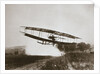 American aviator Glenn Curtiss making the first heavier-than-air flight in his June Bug, 1908 by Edwin Levick