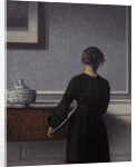 Interior with Young Woman from Behind by Vilhelm Hammershøi