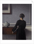 Interior with Young Woman from Behind by Vilhelm Hammershøi