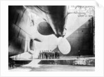 Workmen standing under one of the propellors of the Titanic, 31 May, 1911 by Anonymous