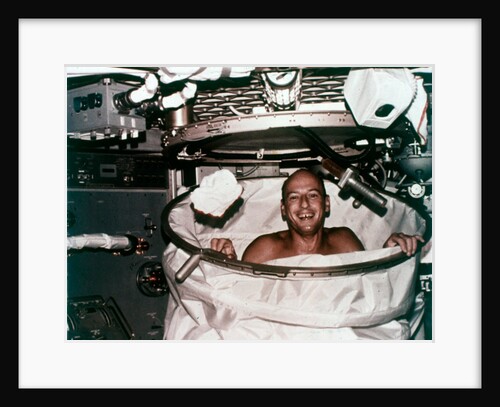 Conrad in shower facility aboard Skylab 2, 1973 by NASA