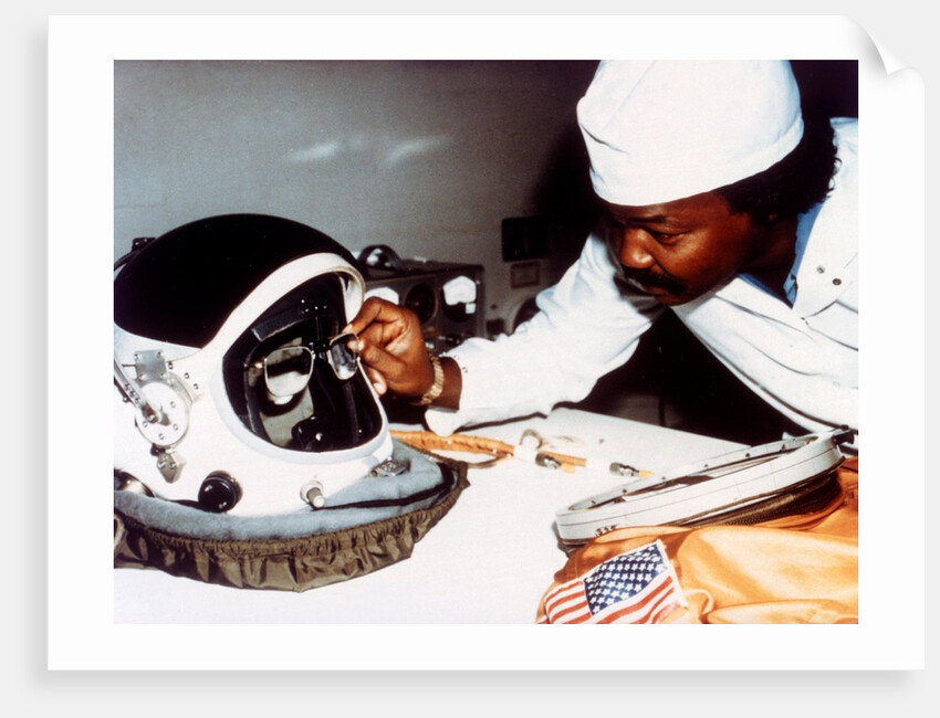 Technician installing eye-glasses in helmet by NASA