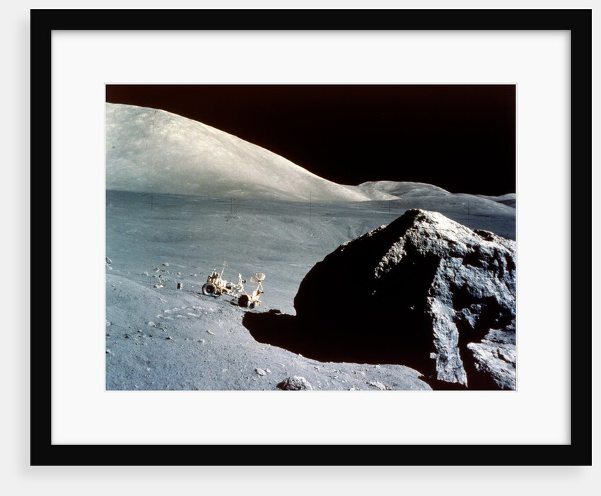 The Rover is dwarfed by a giant rock on the lunar surface, Apollo 17 mission, December 1972 by NASA