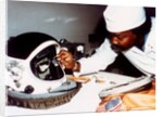 Technician installing eye-glasses in helmet by NASA