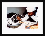 Technician installing eye-glasses in helmet by NASA
