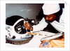 Technician installing eye-glasses in helmet by NASA