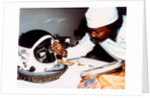 Technician installing eye-glasses in helmet by NASA