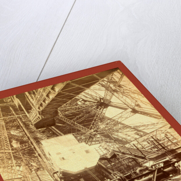 Eiffel Tower Machinery with a Man Beside the Wheel that Raises Elevator by Anonymous