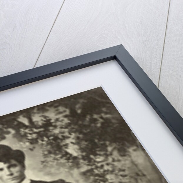 Group portrait of three men and three women, sitting in a studio with painted cloth background (forest or park scene) by Anonymous
