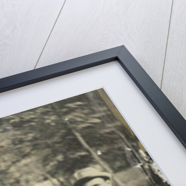 Portrait of three men sitting on a tree stump? In a forest by Anonymous