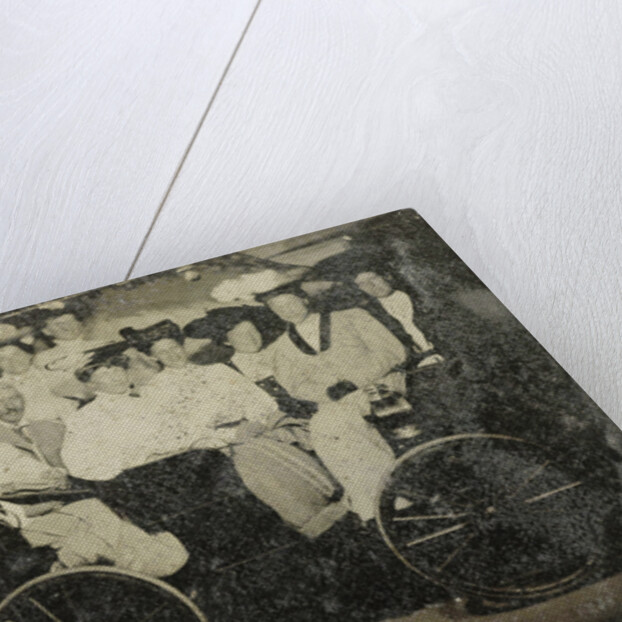 Group portrait of ten women and a man huddled in a carriage in a studio by Anonymous