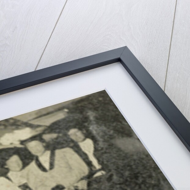 Group portrait of ten women and a man huddled in a carriage in a studio by Anonymous