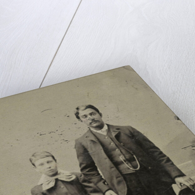 Portrait of a man and a boy, standing in front of a painted backdrop by Anonymous