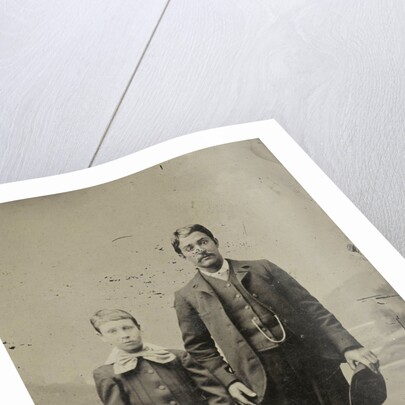 Portrait of a man and a boy, standing in front of a painted backdrop by Anonymous