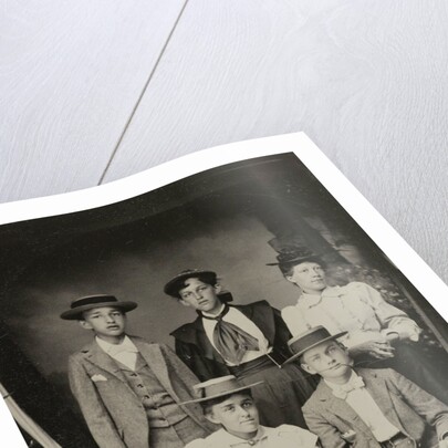 Group portrait of two men and three women, standing and sitting in a cramped studio by Anonymous