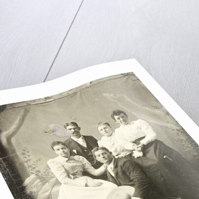 Group portrait of two men and three women, standing and sitting in front of a painted backdrop, tree, rocks by Anonymous