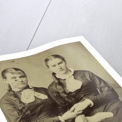 Portrait of two women sitting next to each other and holding each other's hand by Anonymous