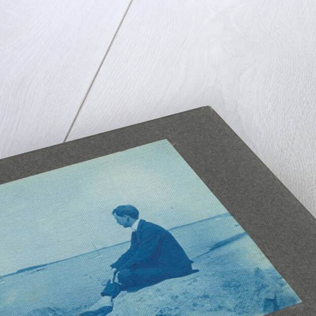 Man in profile, sitting on a rock by the sea, United States, Cyanotype, a photographic printing process that produces a cyan-blue print by Anonymous