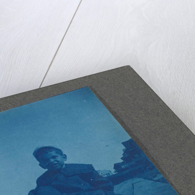 Boy sitting on wooden planks, USA by Anonymous