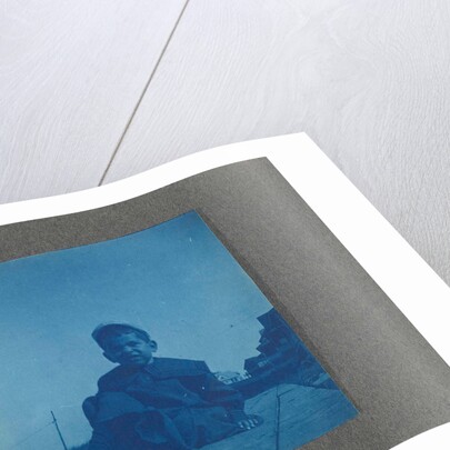 Boy sitting on wooden planks, USA by Anonymous
