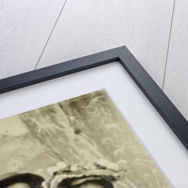 Portrait of a man and two women in front of a painted backdrop (tree, lake and mountains) and a sign that read 'Huntington FAIR 1905 by Anonymous