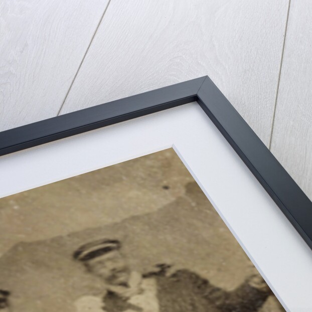 Group portrait of three men and two women in visible cheerful mood, standing and sitting in front of a painted backdrop showing a mountain castle by Anonymous