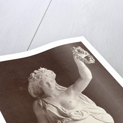 Marble statue of a woman in a robe with a bare chest, in her left hand she wears a laurel wreath in her right a ship's anchor by Louis-Emile Durandelle