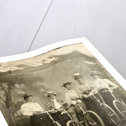Group portrait of five women with bikes for a painted backdrop with forest by Anonymous