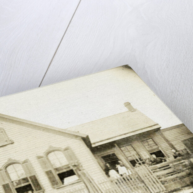 View of a wooden house with about nine people before or standing in doorways, United States by Anonymous