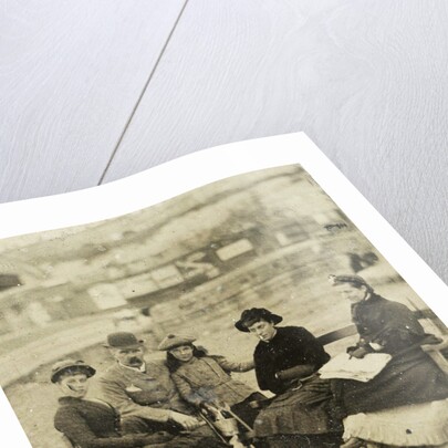 Three women, a man and a girl on the beach by Anonymous